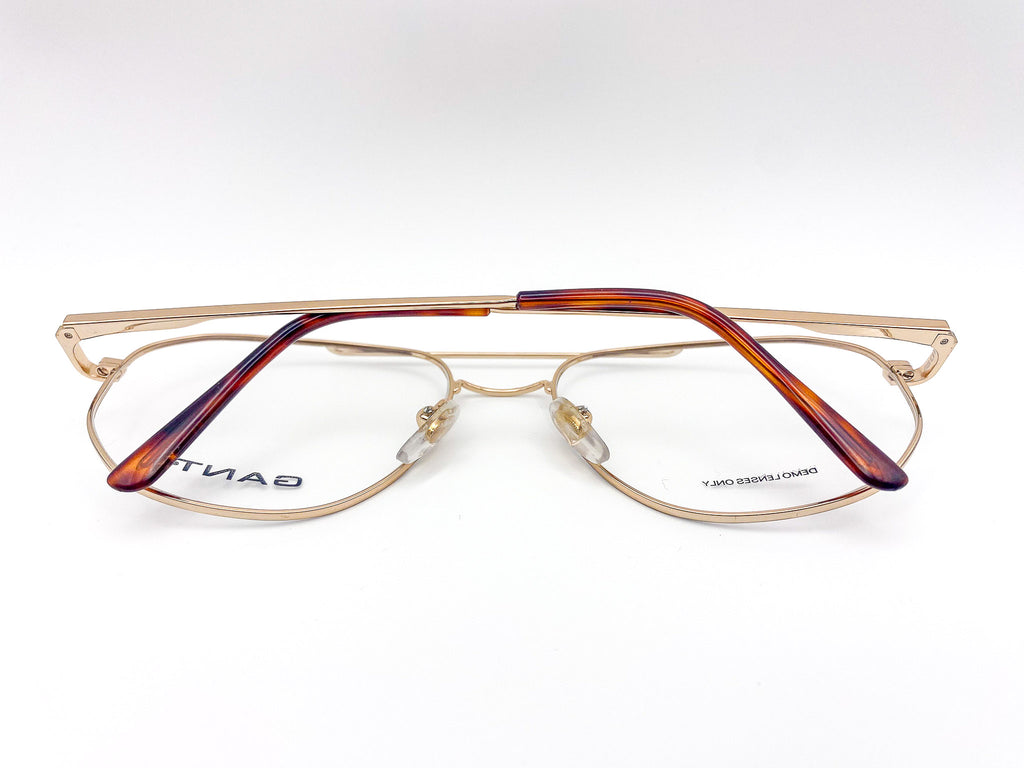 Gold and tortoiseshell eyeglasses on a white background