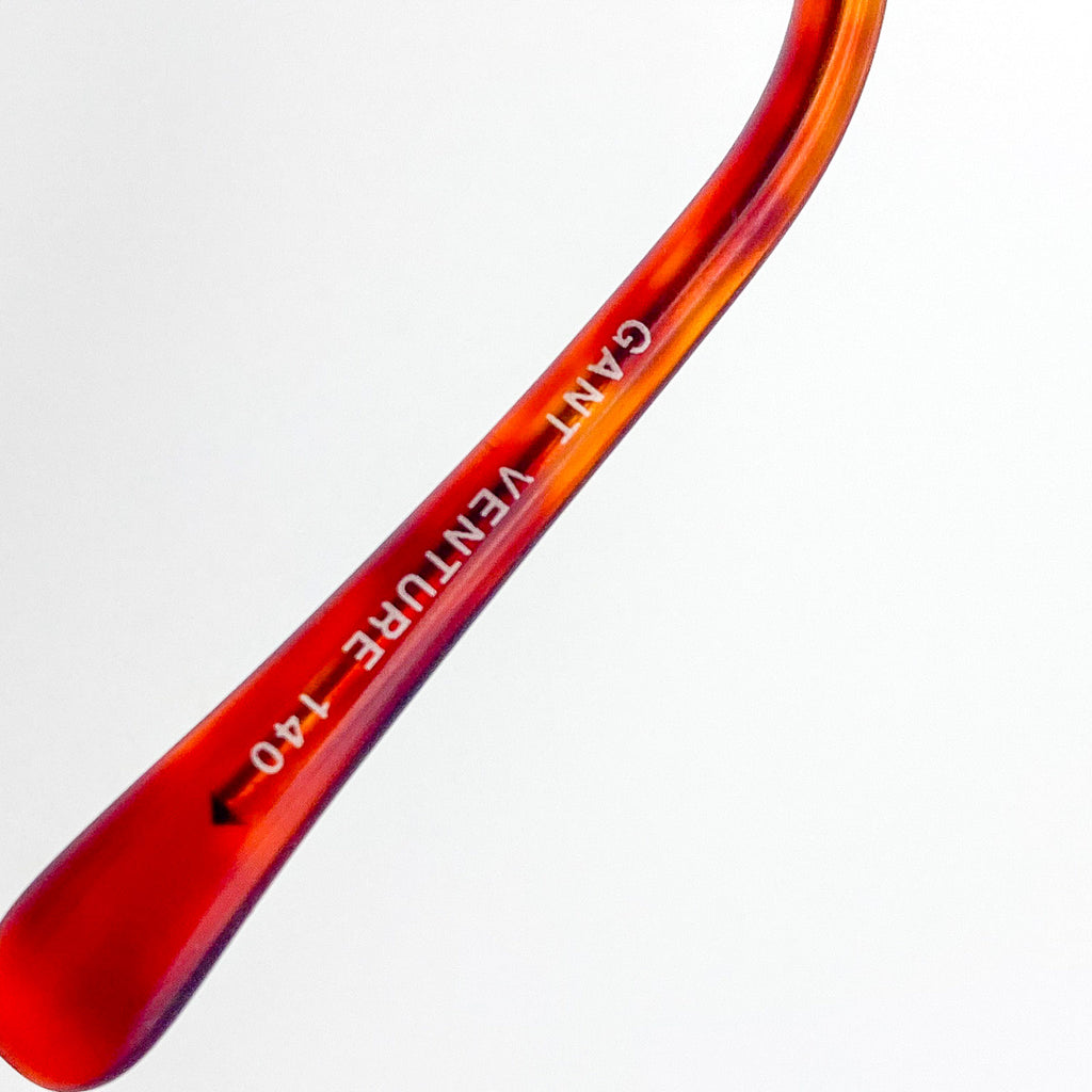 Red and black GANT Venture 140 temple arm on a white background