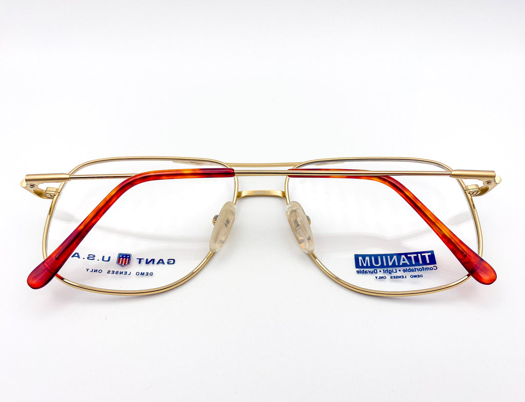 Gold eyeglasses with 'Gant' branding on a white background