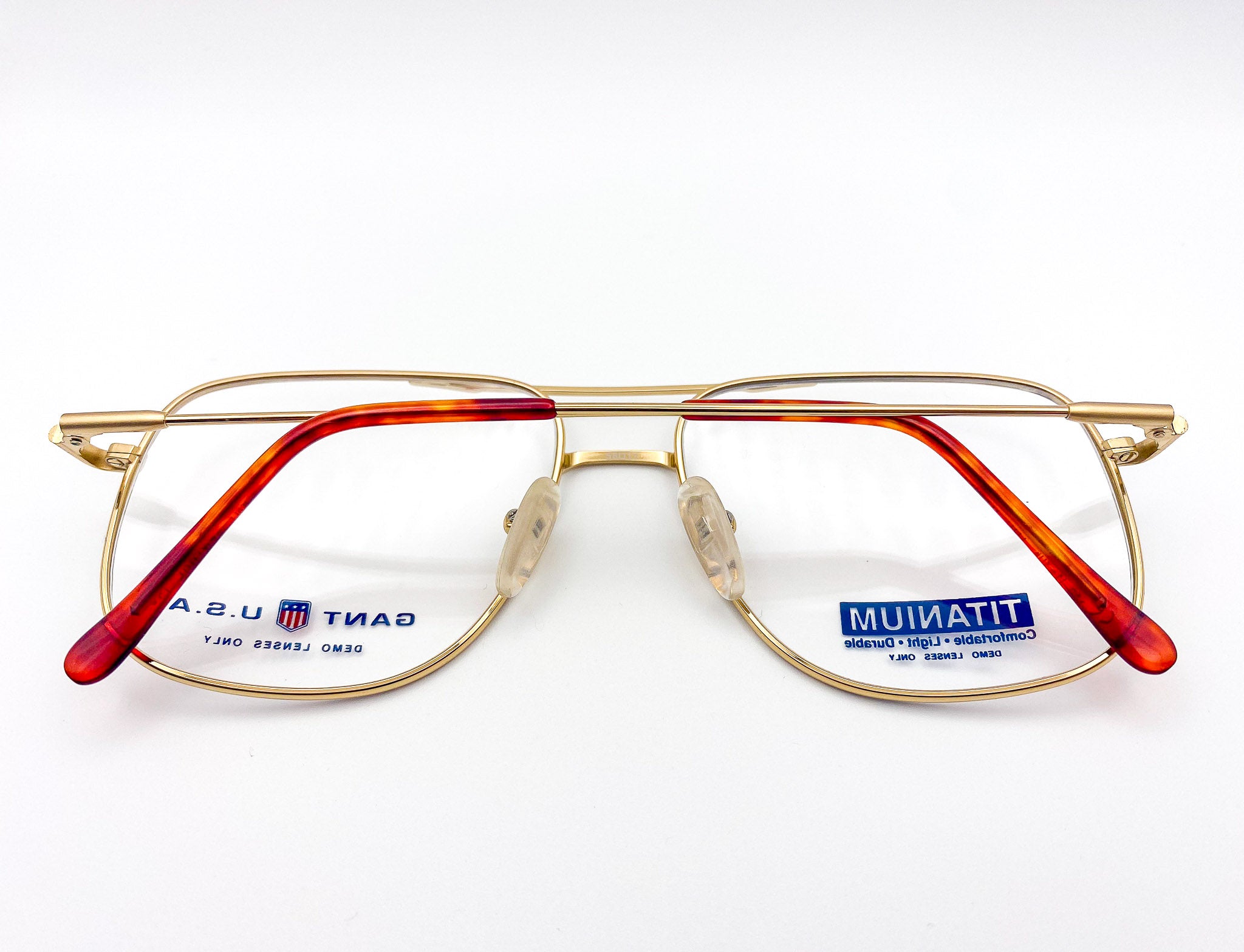 Gold eyeglasses with 'Gant' branding on a white background