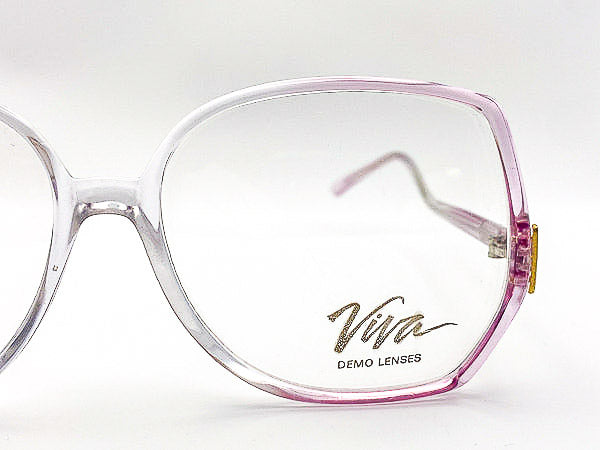 Eyeglasses with purple frame and 'Viva' branding on a white background