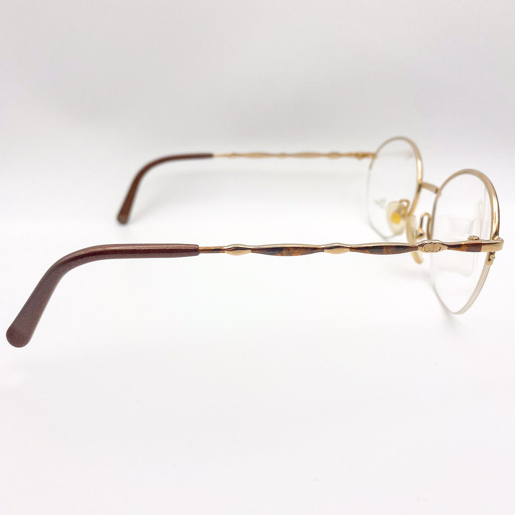 Pair of eyeglasses with gold frame on a white background