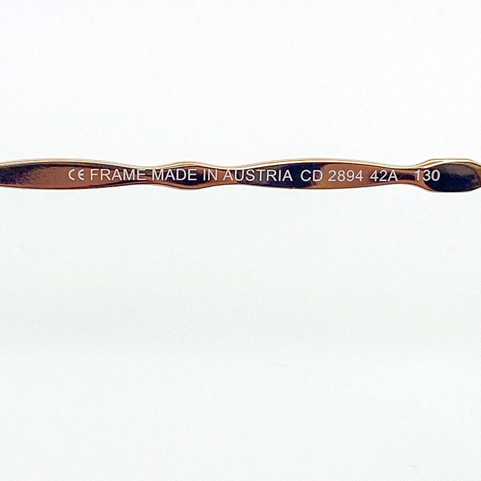 Eyeglass temple bar with 'Made in Austria' text on a white background