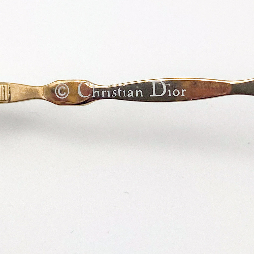 Metallic temple arm with 'Christian Dior' branding on a white background
