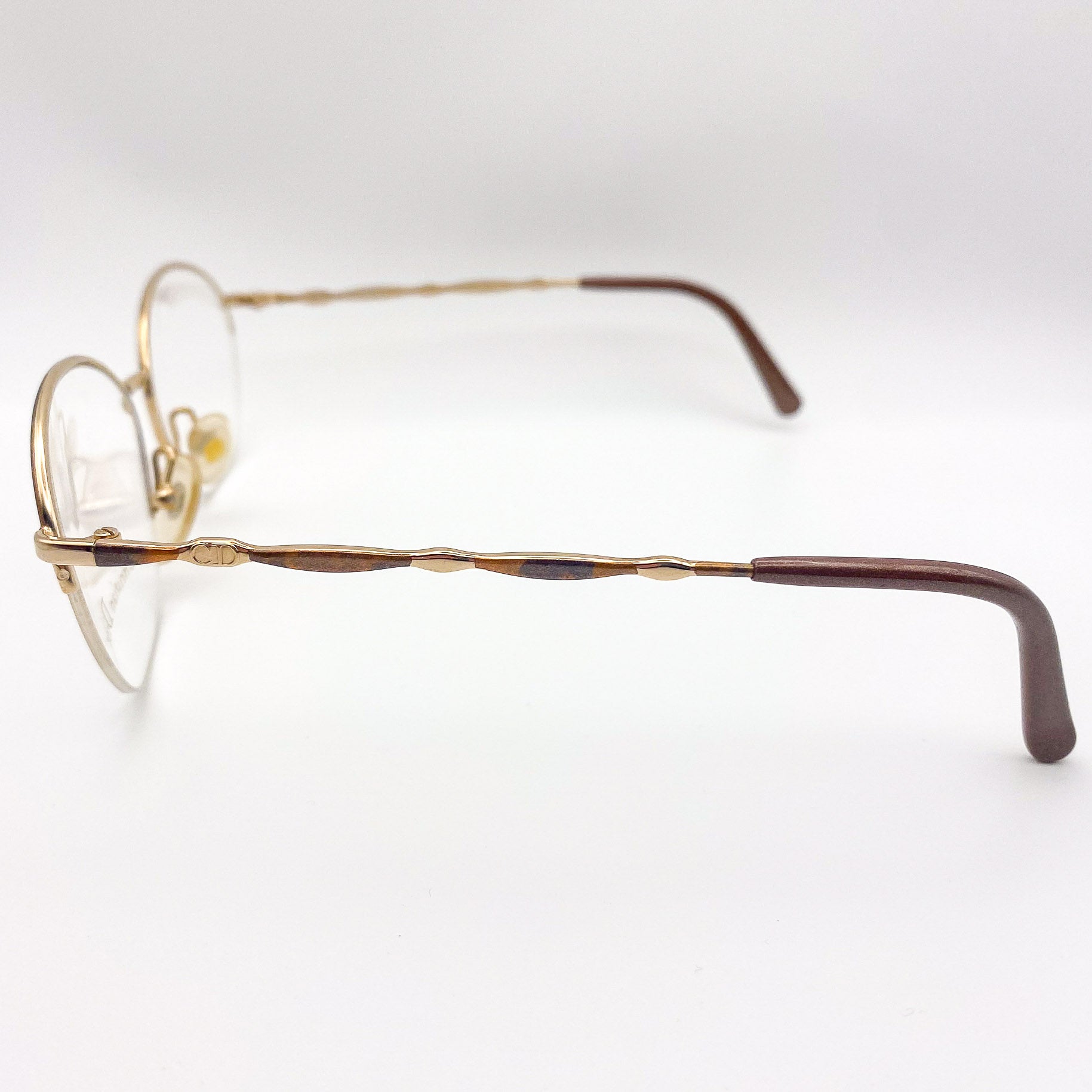 Gold-framed eyeglasses on a white background