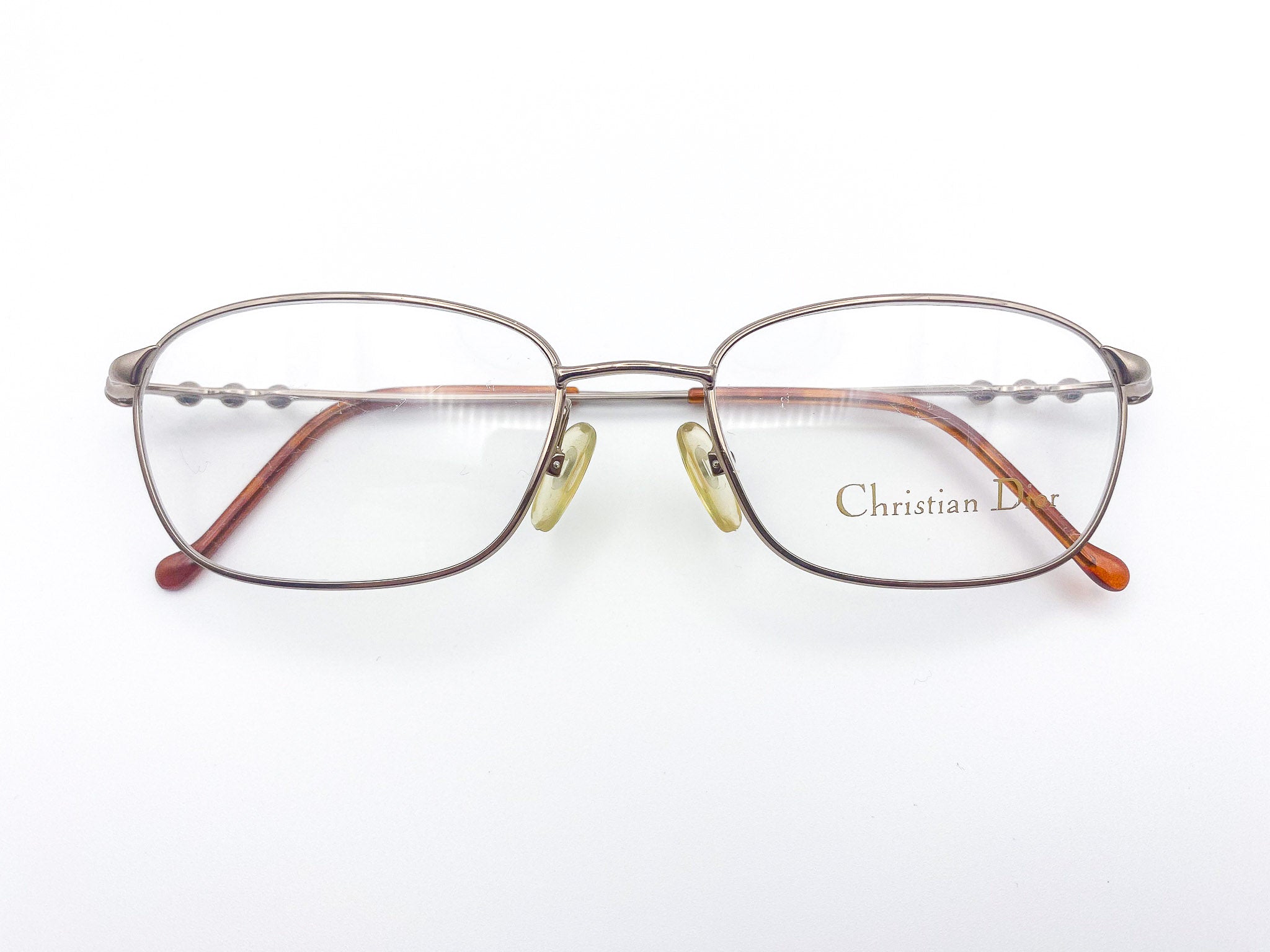 Gunmetal grey eyeglasses with 'Christian Dior' branding on a white background