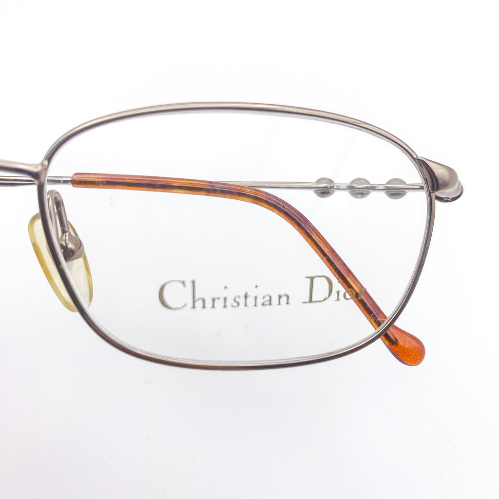 Close-up of a vintage Christian Dior eyeglasses frame on a white background