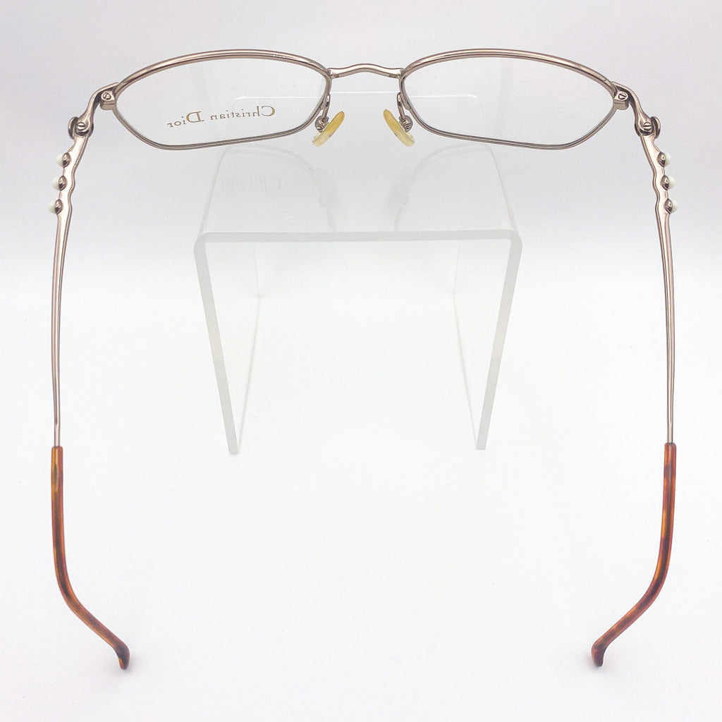 Eyeglasses with brown temple tips on a white background