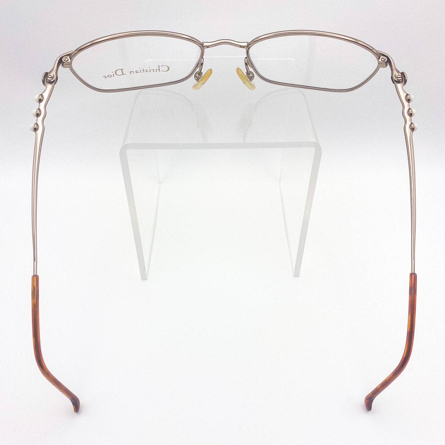 Eyeglasses with brown temple tips on a white background