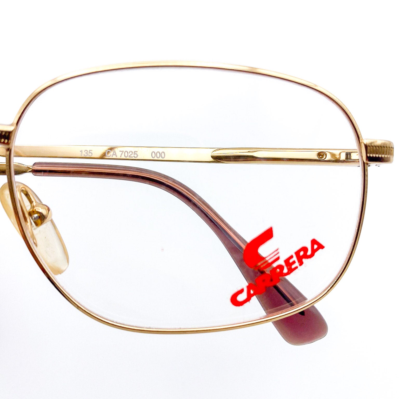Gold-framed glasses with Carrera logo on a white background