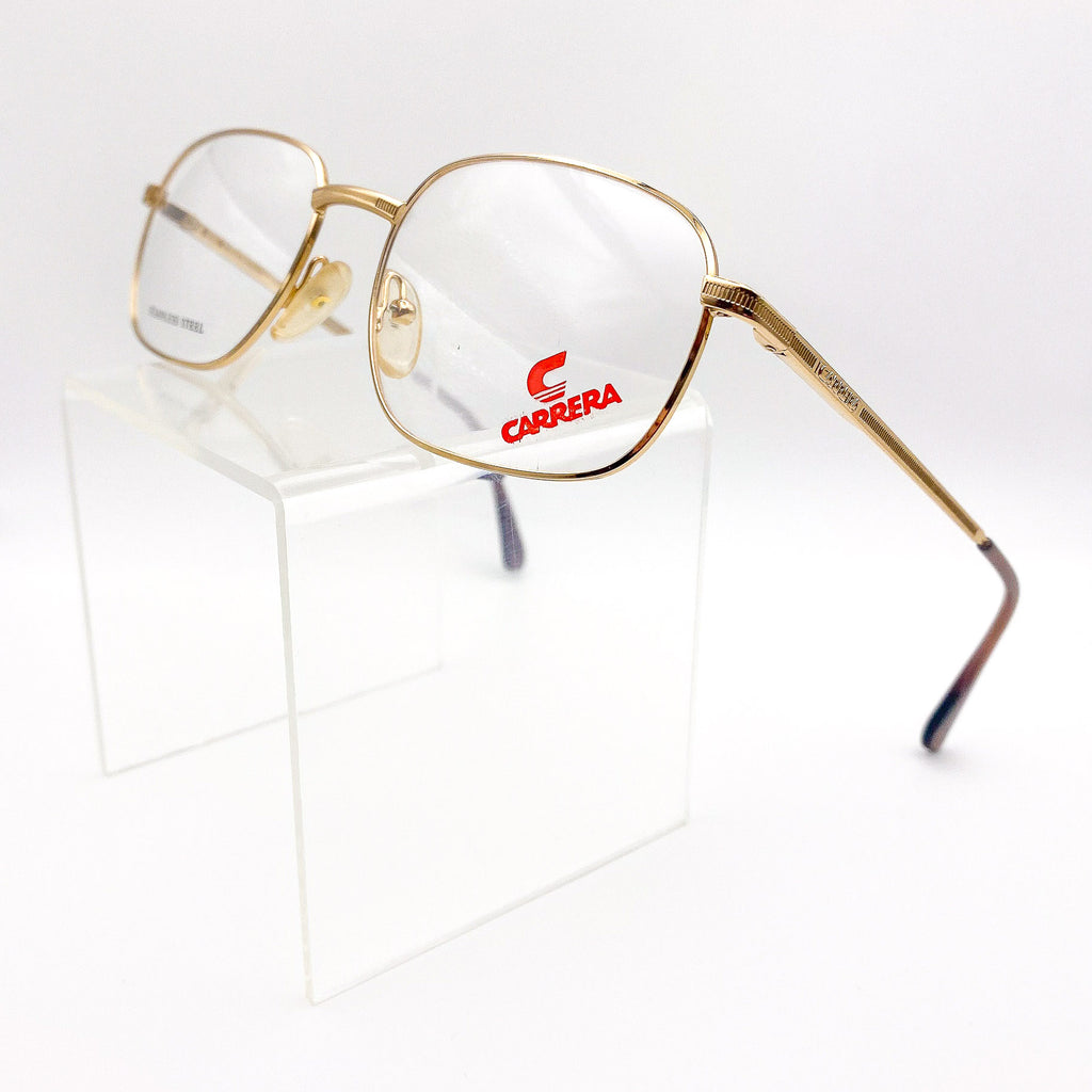 Gold-framed Carrera eyeglasses on a white background