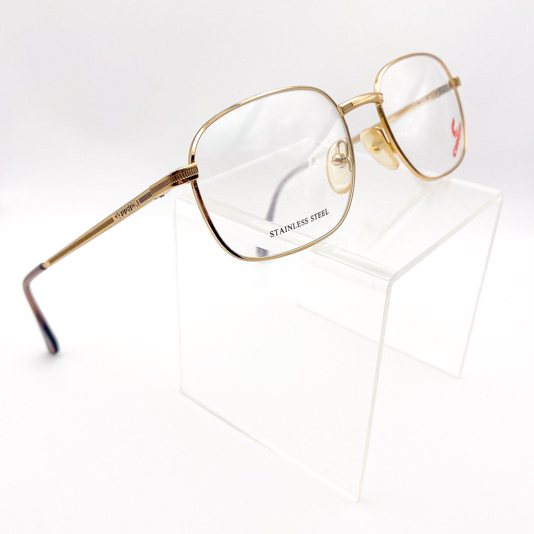 Gold-framed rectangular eyeglasses on a white background