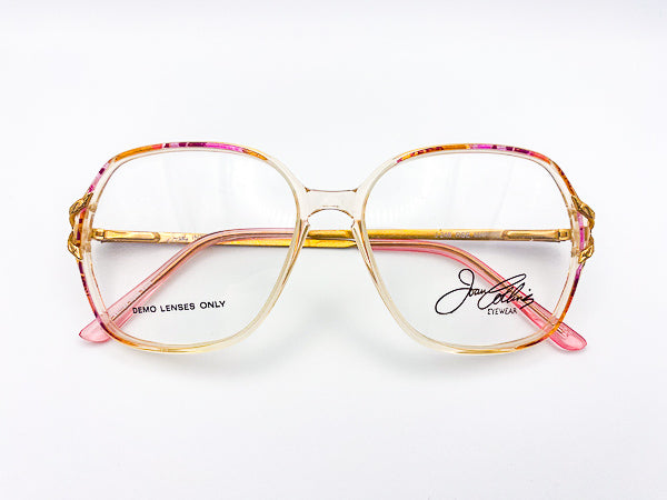 Vintage gold and pink eyeglasses with 'Joan Collins' branding on a white background