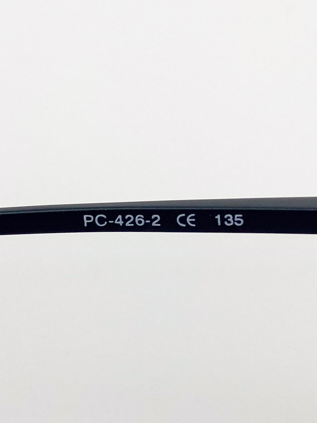 Black eyeglass stem with 'PC-426-2', 'CE', and '135' text on a white background