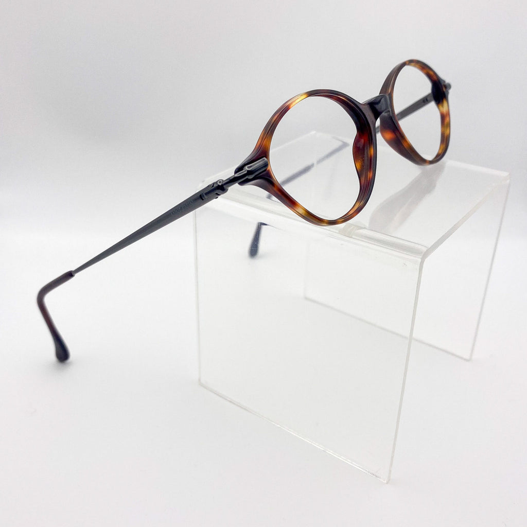 Round eyeglasses with tortoiseshell frame on a white background