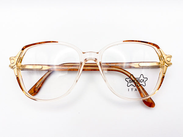 Vintage Luxottica eyeglasses with a tortoiseshell frame on a white background