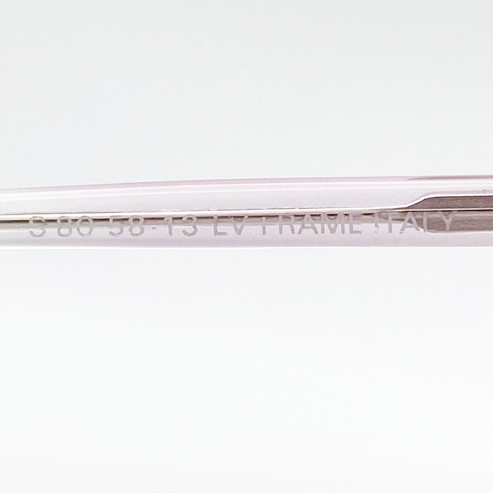 Clear plastic glasses frame with engraved text on a white background