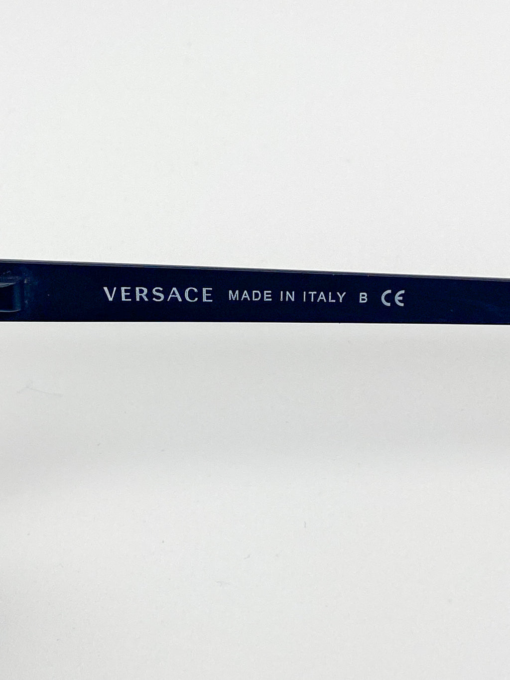 Versace eyeglasses with 'Made in Italy' text on a white background