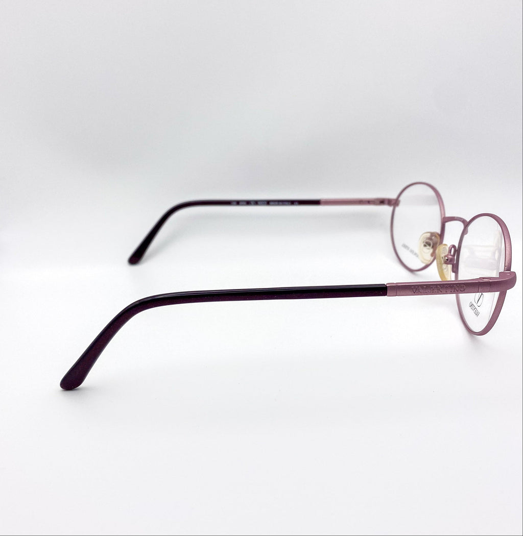 Eyeglasses with a lavender and black frame on a white background
