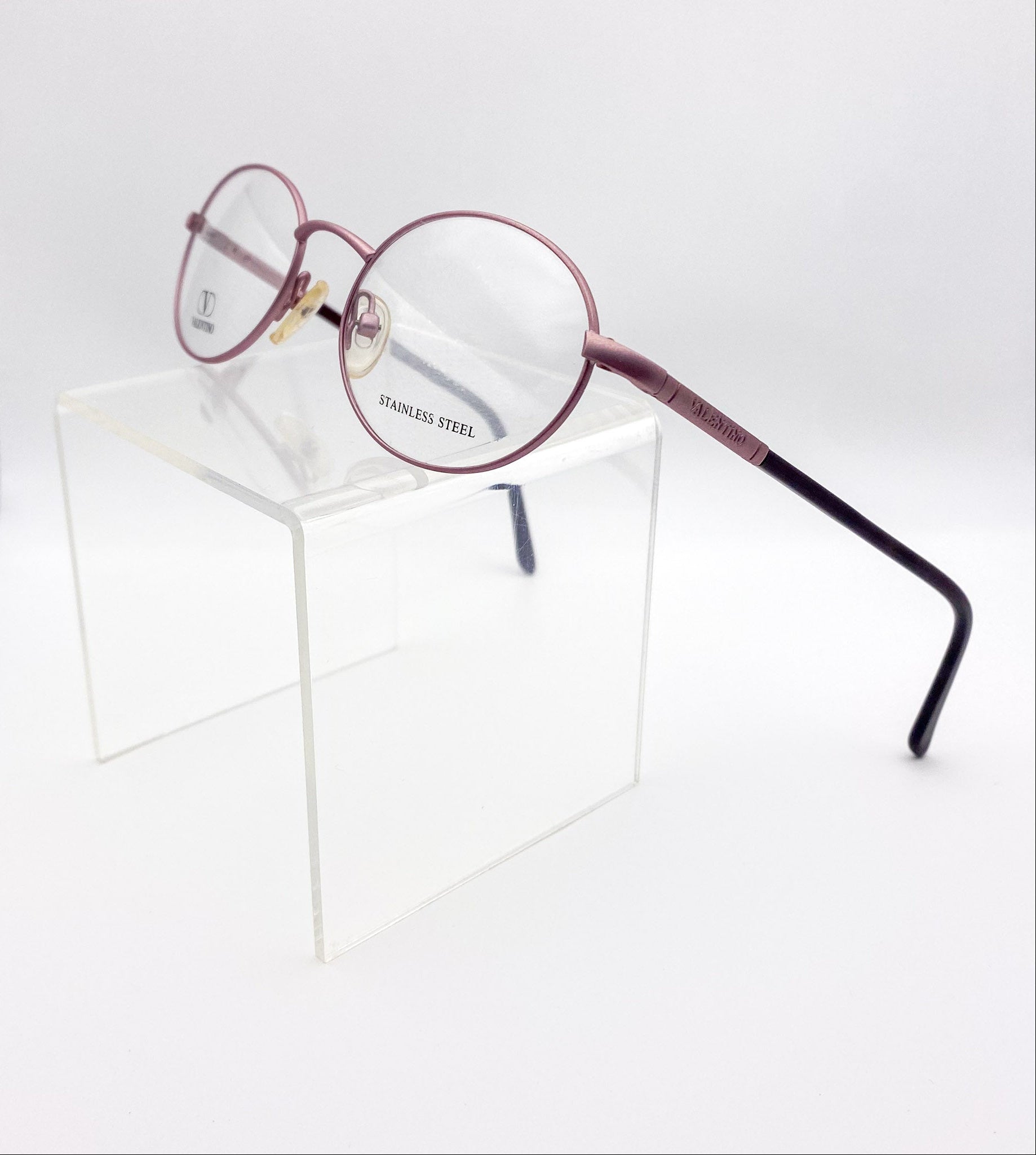 Vintage round eyeglasses with lavender frame on a white background