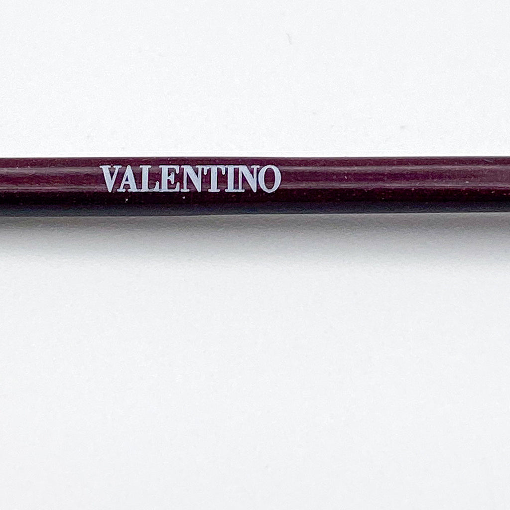 Eyeglasses temple stem with 'Valentino' branding on a white background
