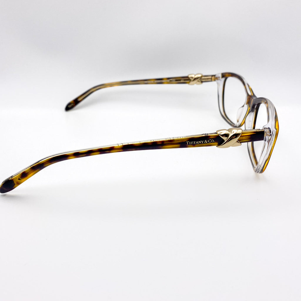2000s era tortoiseshell eyeglasses with gold accents on a white background