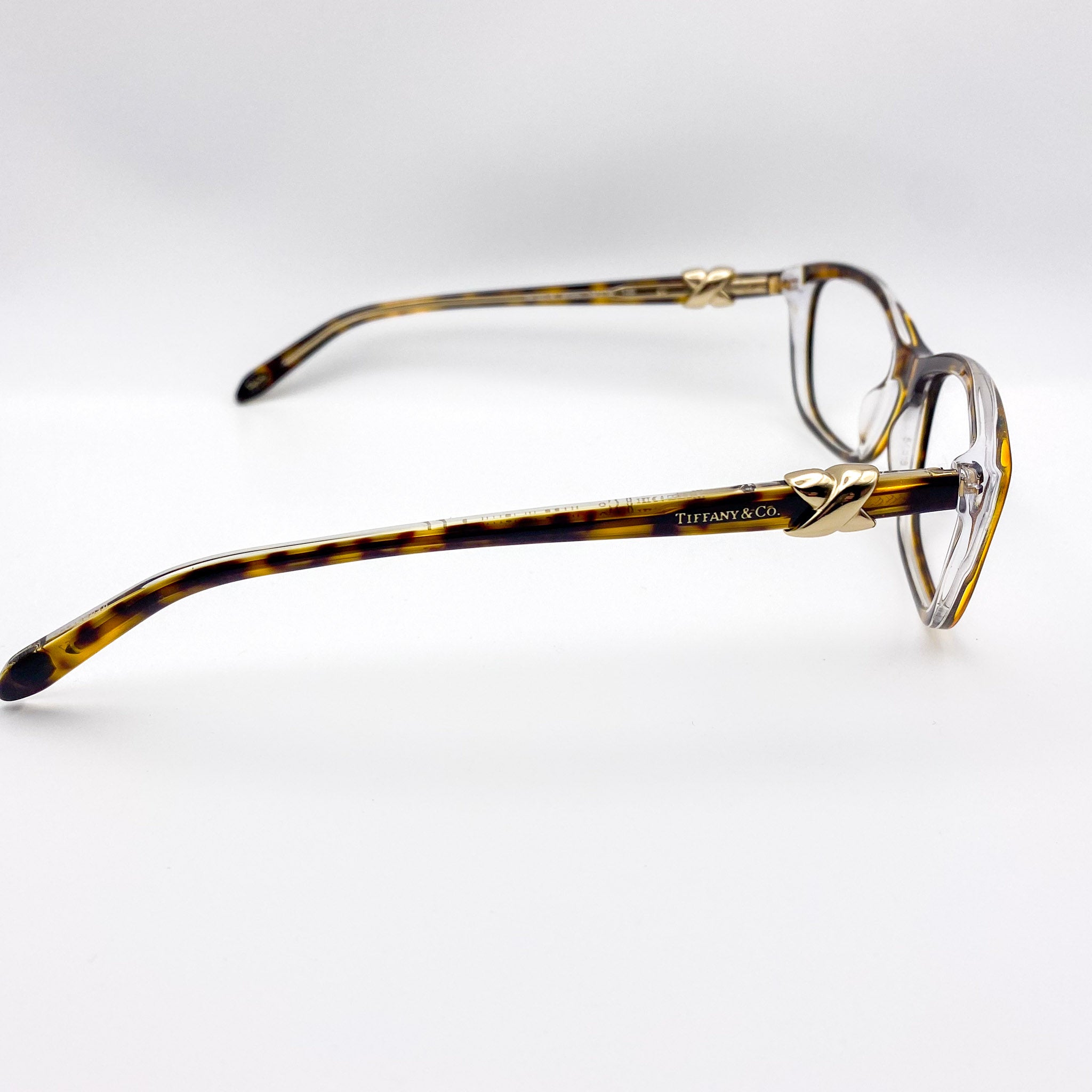 2000s era tortoiseshell eyeglasses with gold accents on a white background