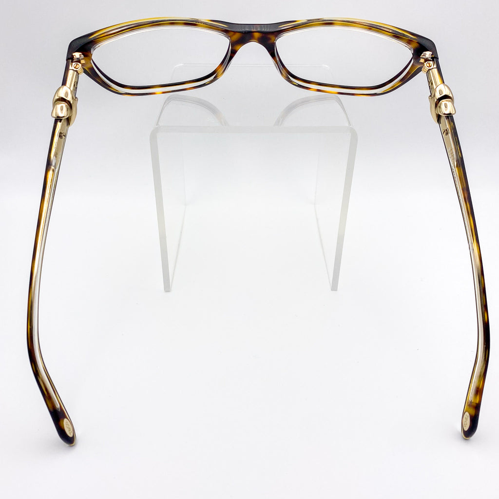 Tortoiseshell eyeglasses with gold accents on a white background