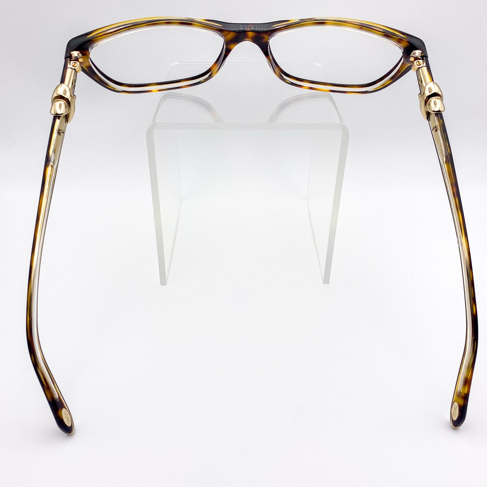 Tortoiseshell eyeglasses with gold accents on a white background