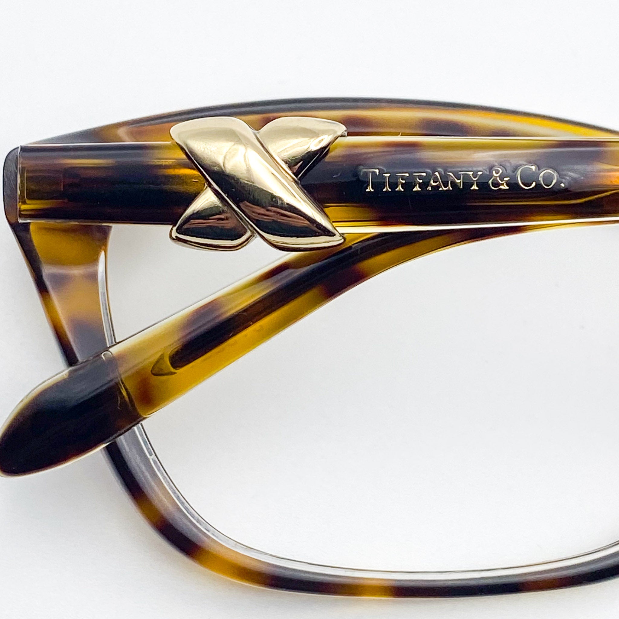 Tortoiseshell eyeglasses with gold accents and 'Tiffany & Co.' branding on a white background