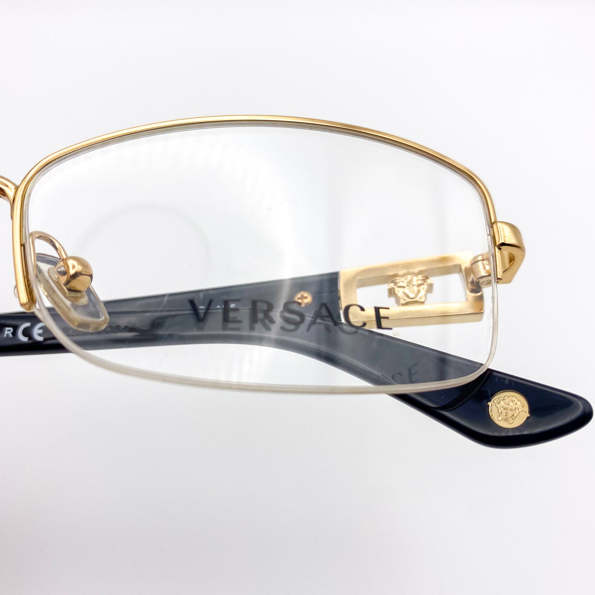 Gold Versace eyeglasses on a white background