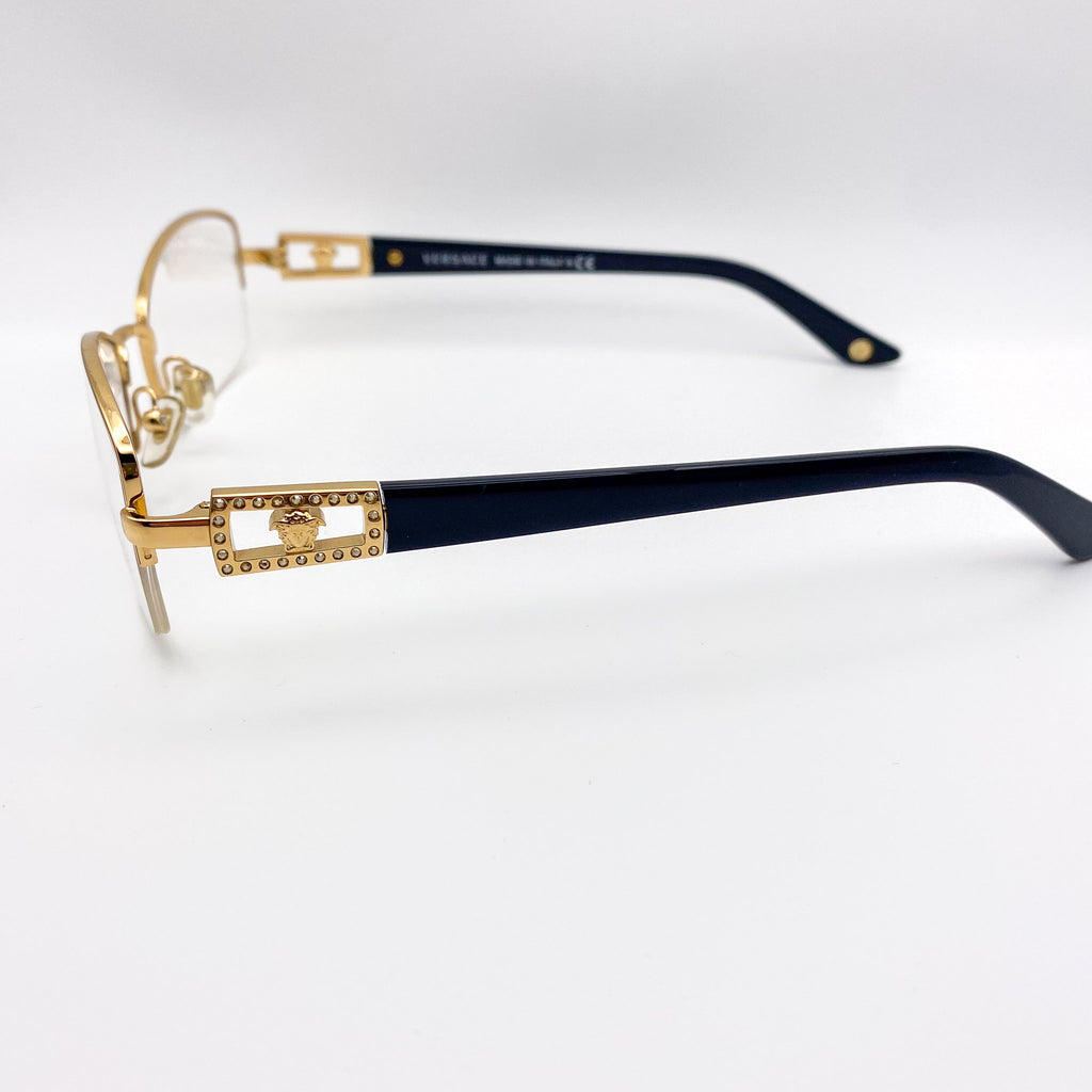 Gold and black vintage eyeglasses on a white background