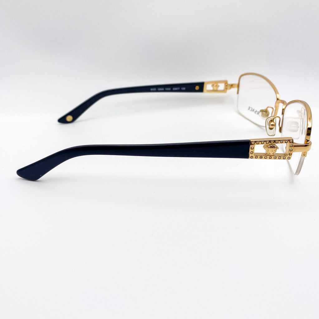 1990s gold and black eyeglasses on a white background