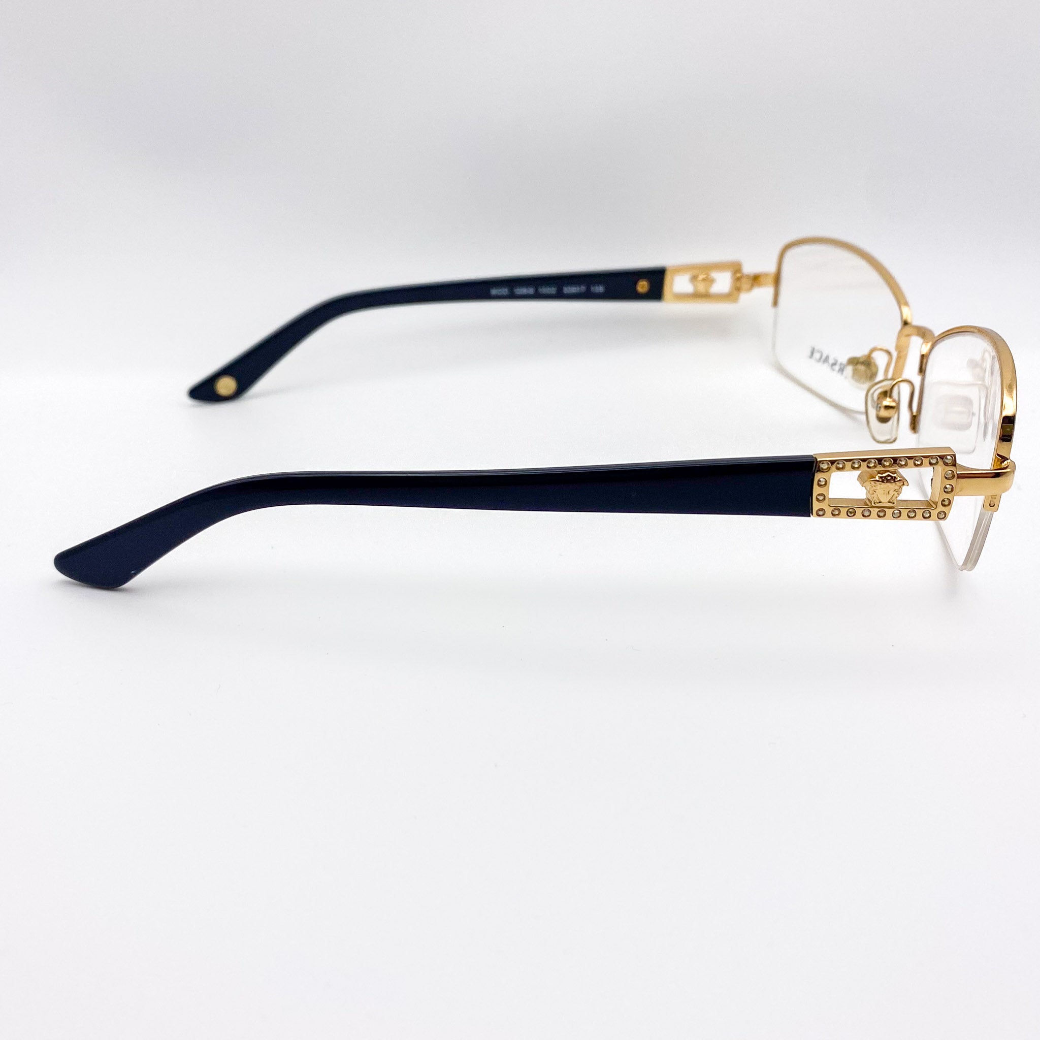 1990s gold and black eyeglasses on a white background