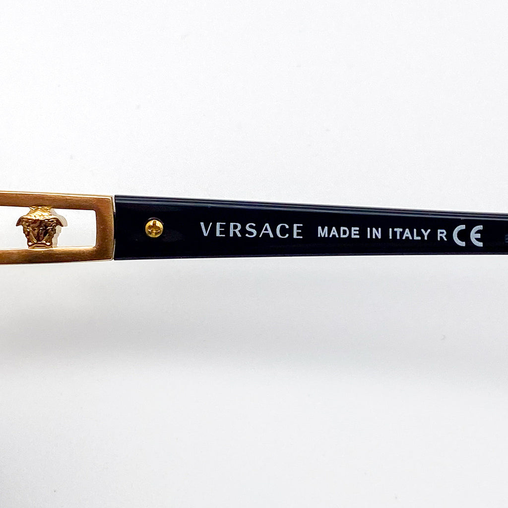 Versace black eyeglasses with gold detail on a white background