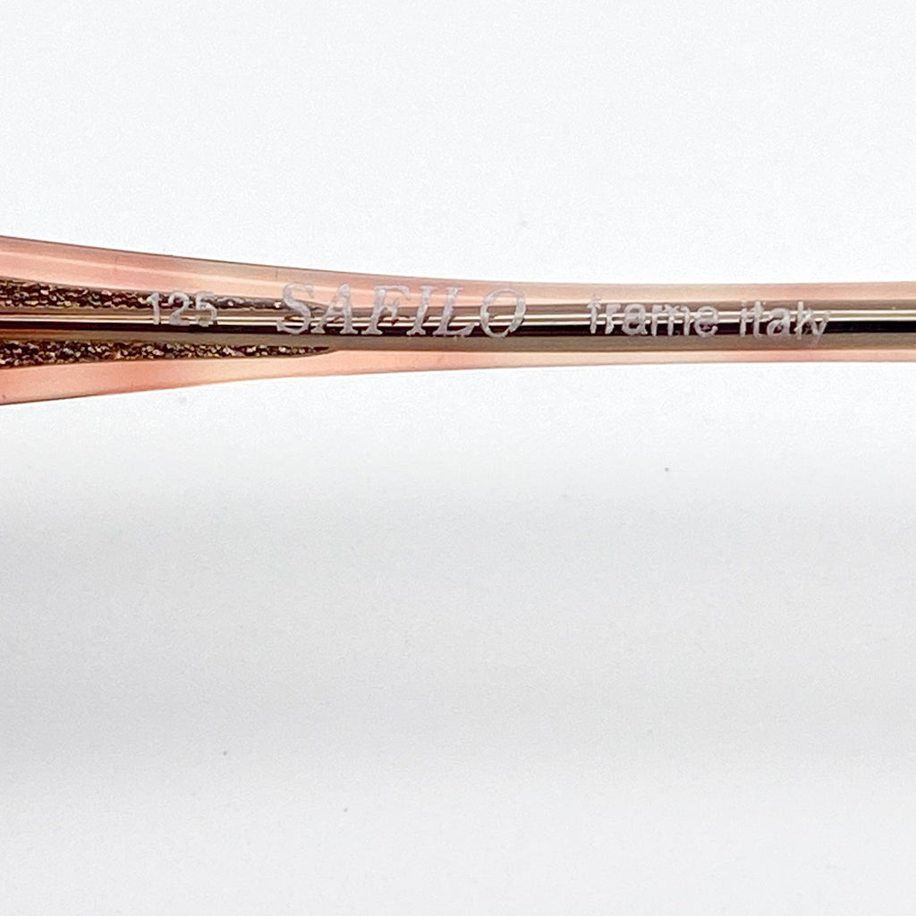 Rose gold eyeglasses with 'SAFILO frame Italy' engraving on a white background