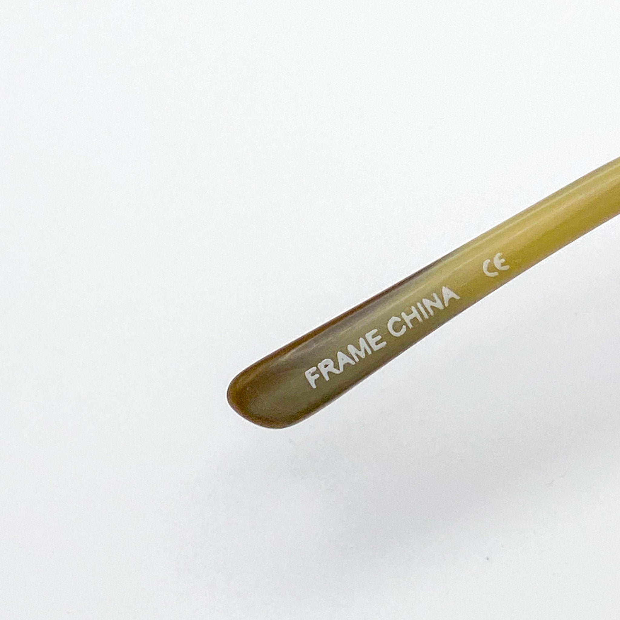 Glasses temple tip with 'FRAME CHINA' branding on a white background