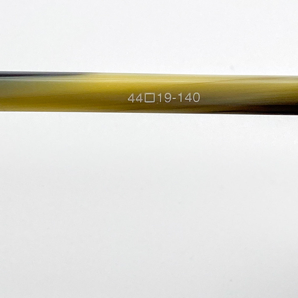 Close-up of an eyeglass temple arm with text on a white background