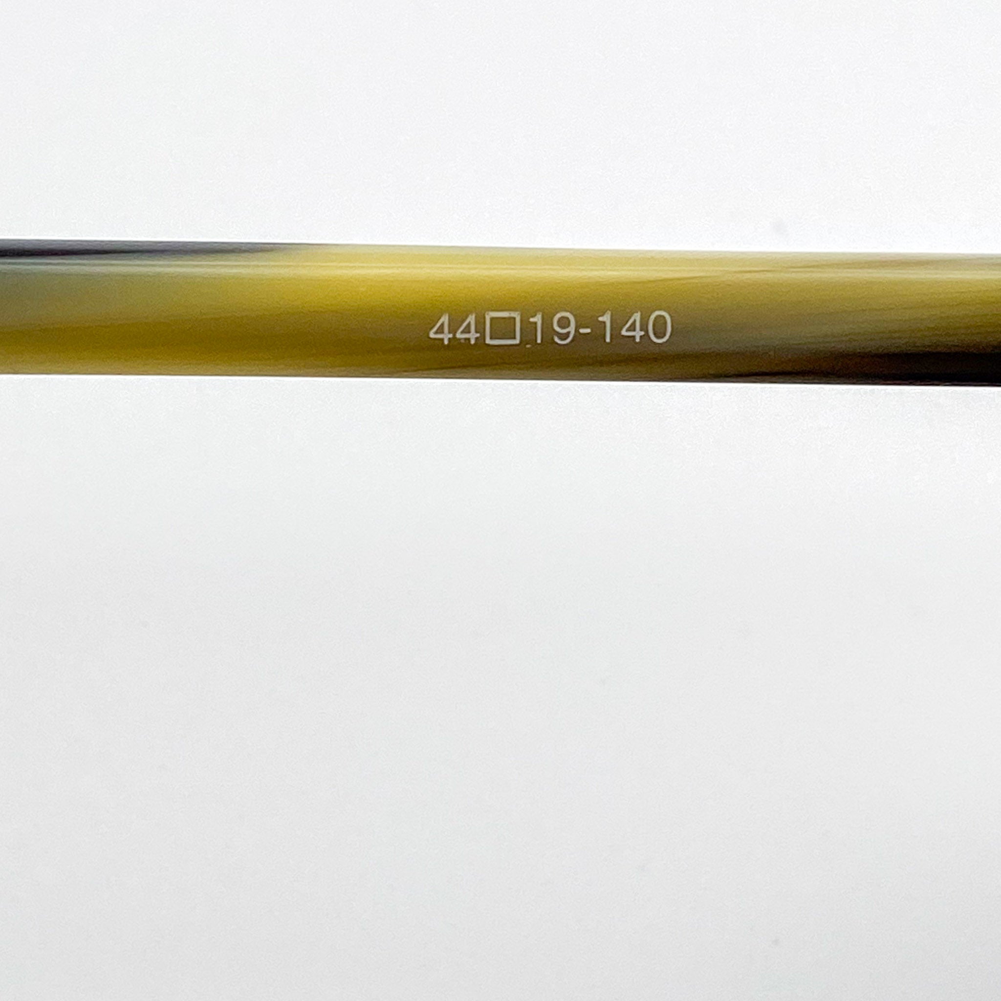 Close-up of an eyeglass temple arm with text on a white background