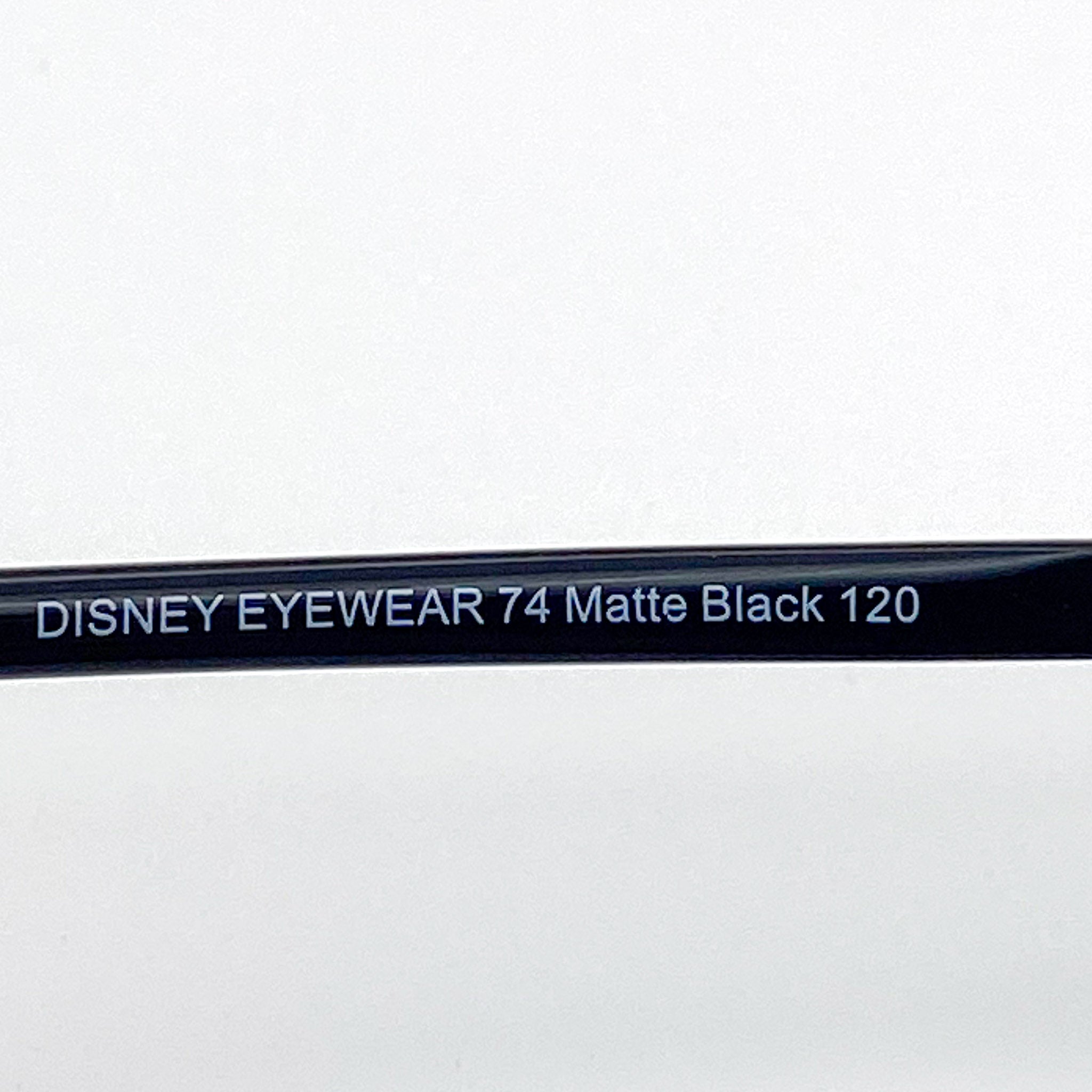 Close-up of a Disney Eyewear frame with model number 74 Matte Black 120 on a white background