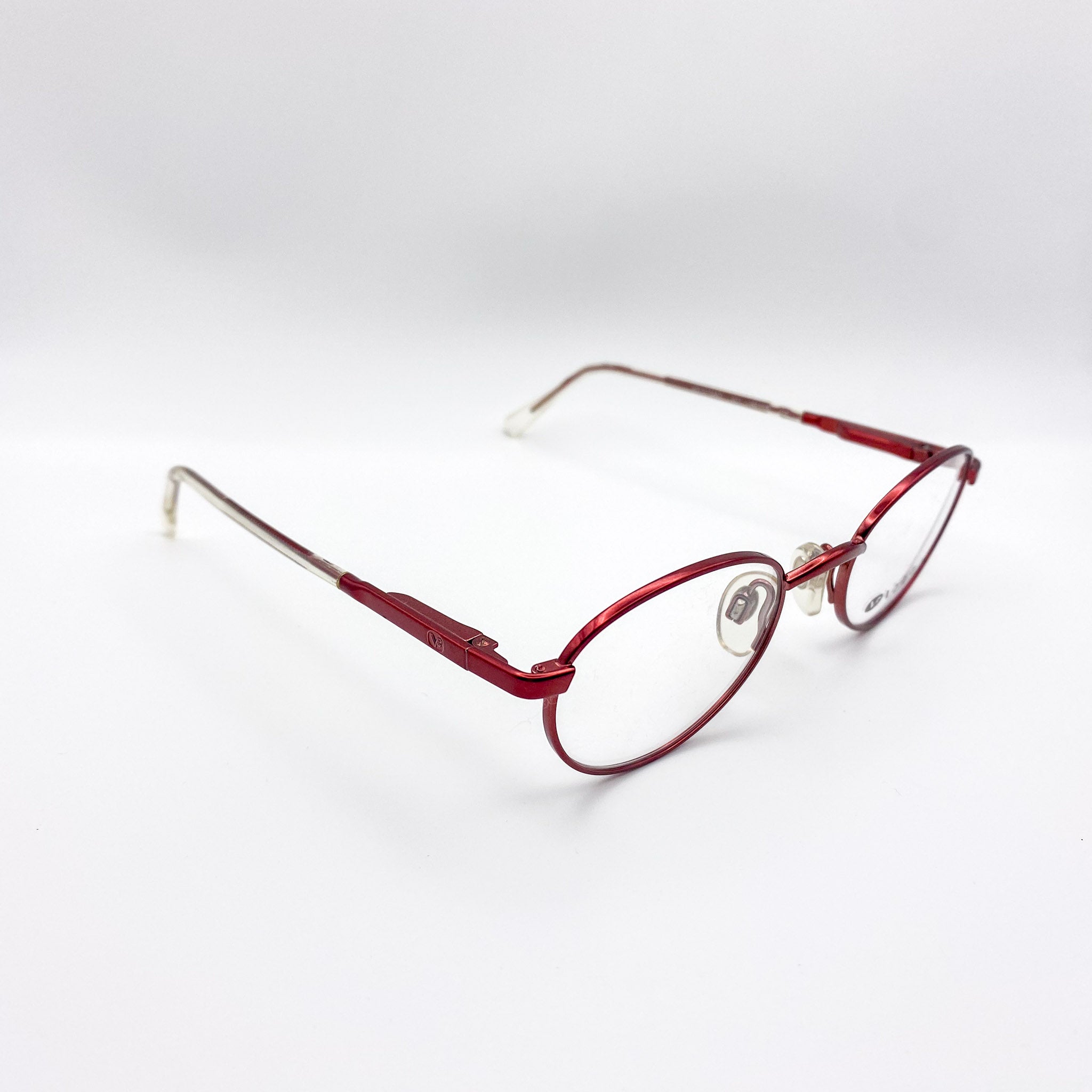 Red metal eyeglasses on a white background