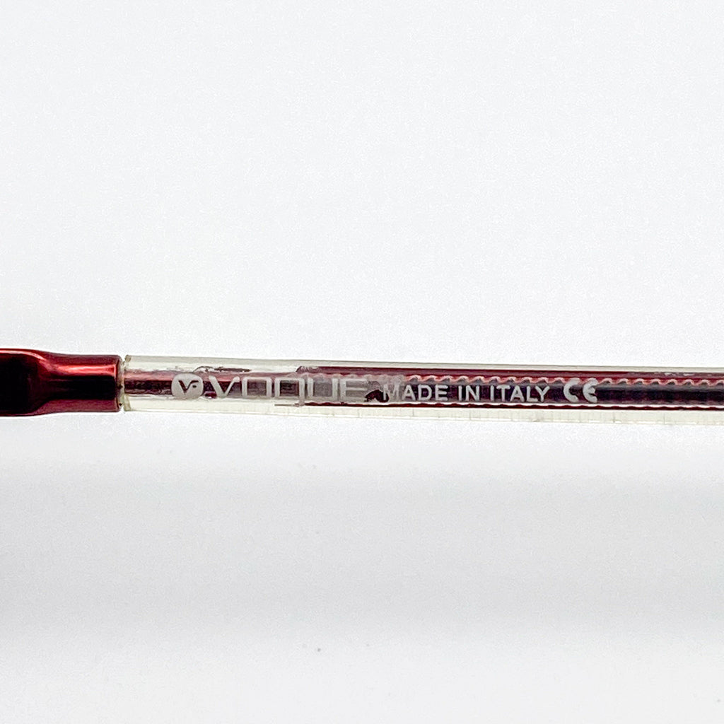 Red eyeglasses frame with 'Made in Italy' text on a white background