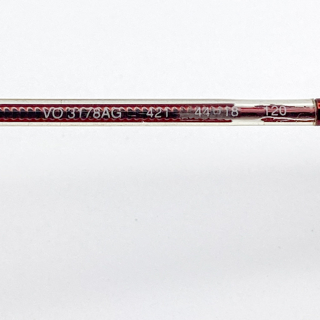 Close-up of glasses with visible branding and model number on a white background