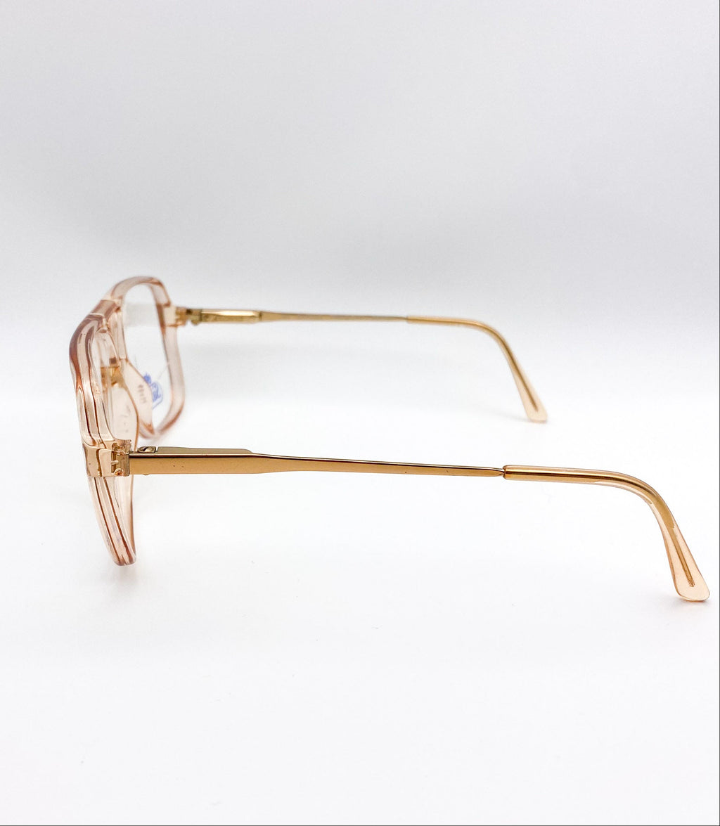 Gold-framed eyeglasses on a white background