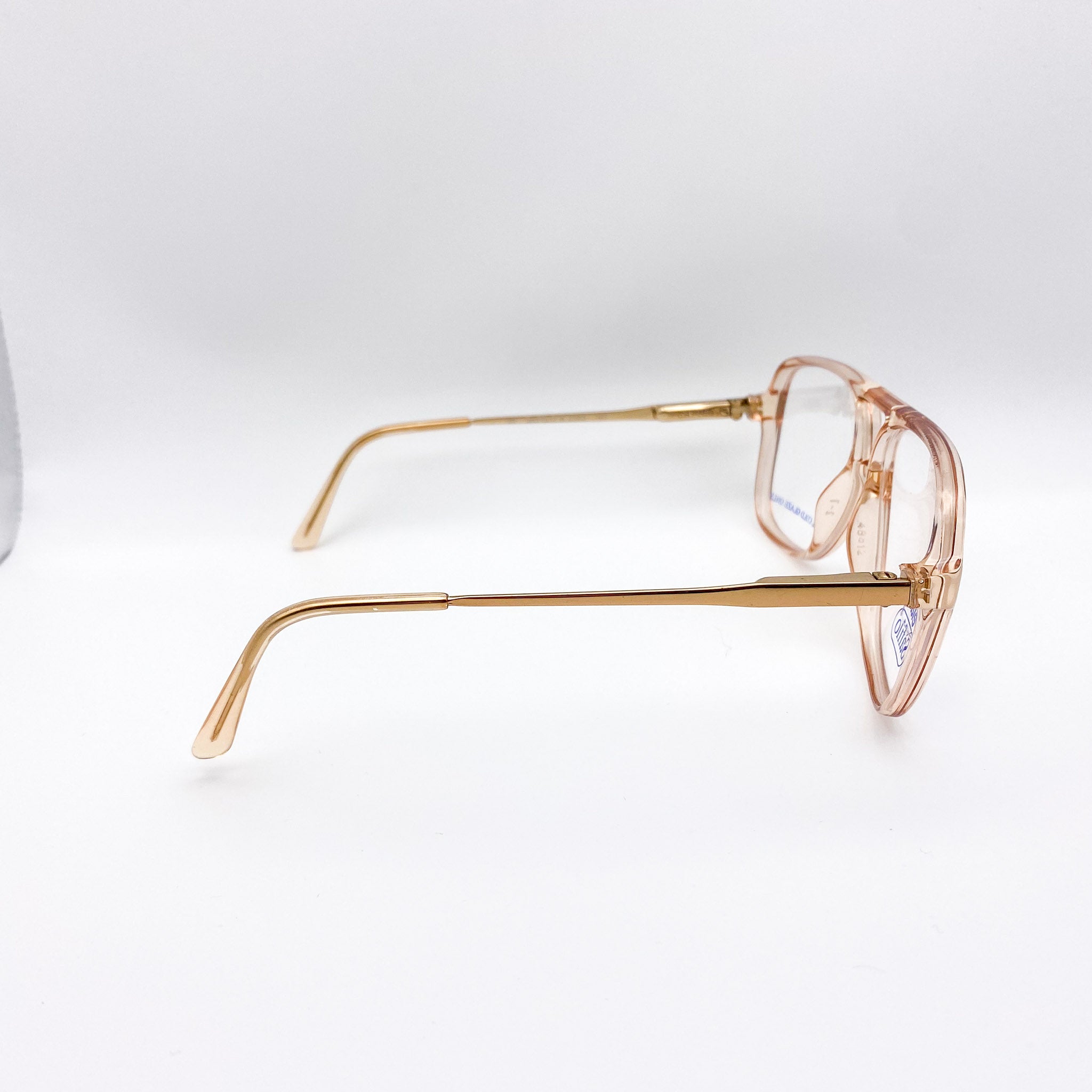 Gold-framed eyeglasses on a white background