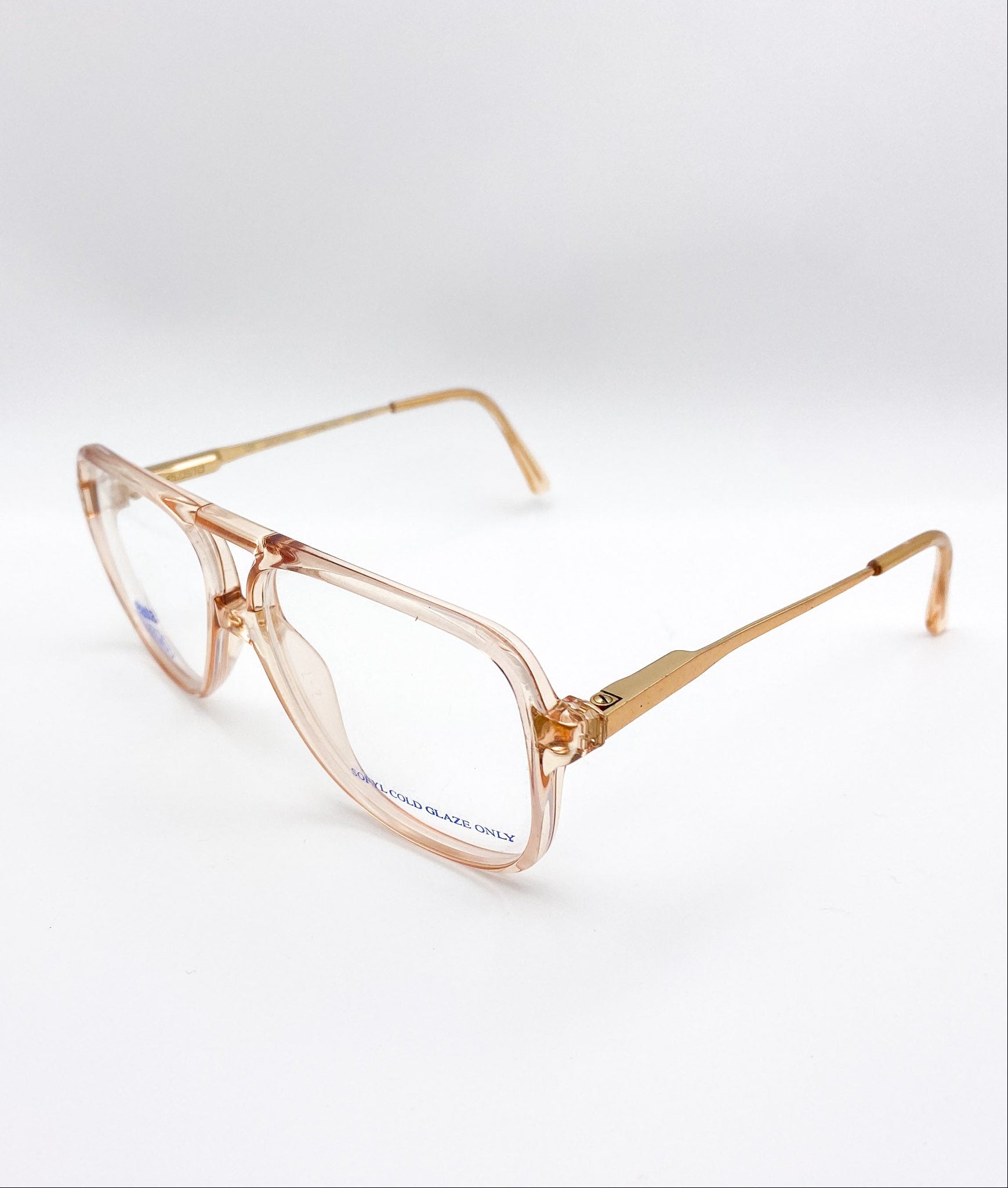 Gold-framed eyeglasses on a white background