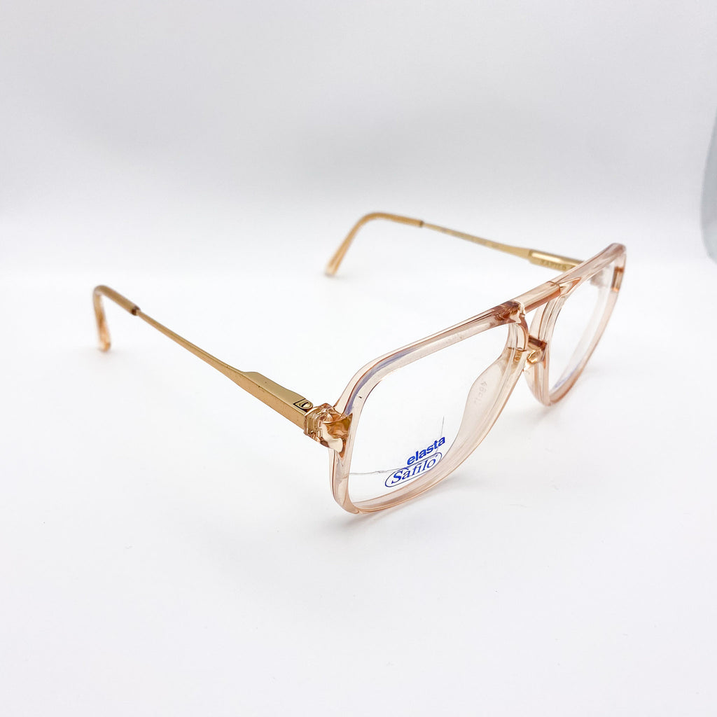 Translucent amber eyeglasses with a visible brand logo on a white background