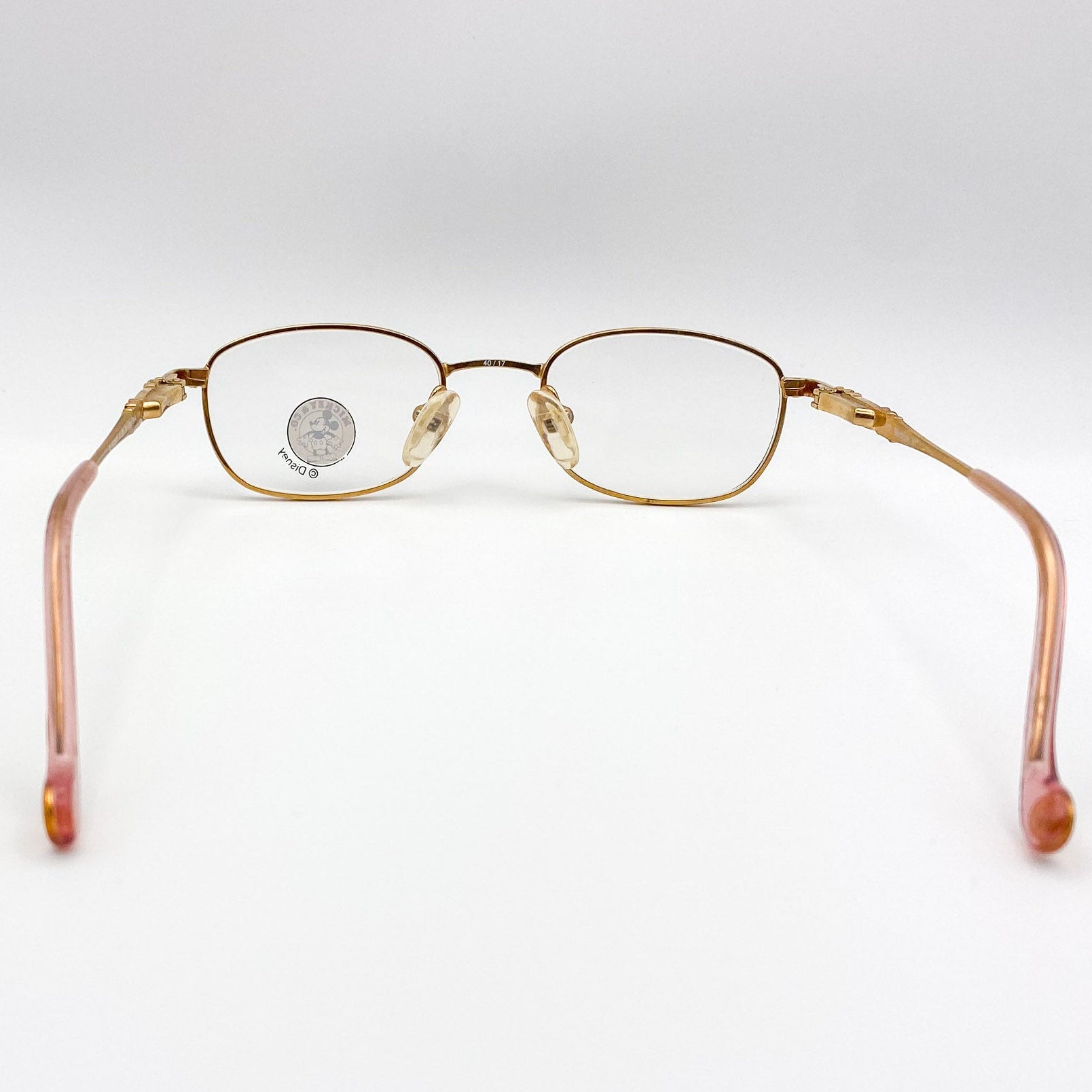 Gold-framed eyeglasses on a white background