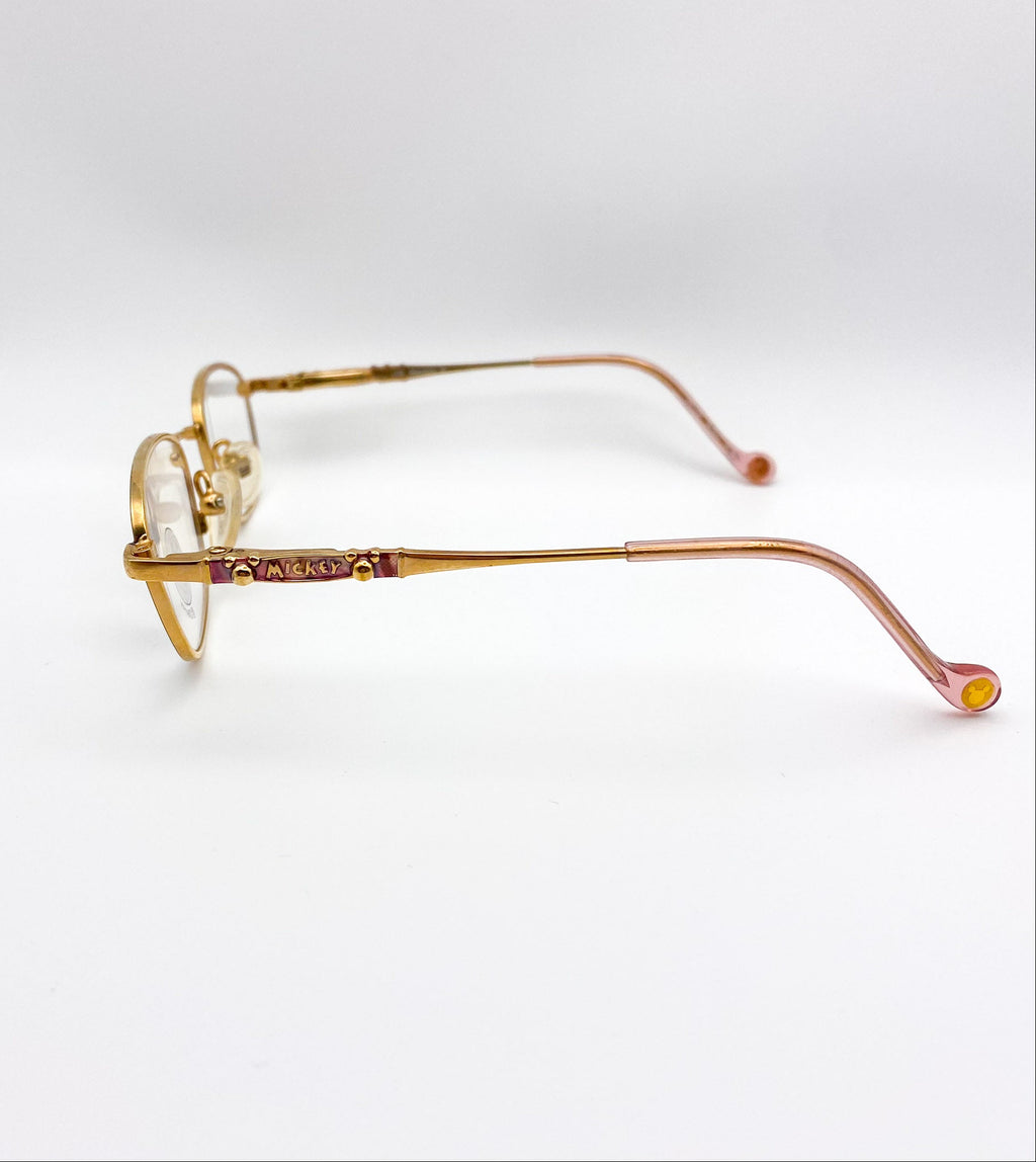 Gold eyeglasses on a white background