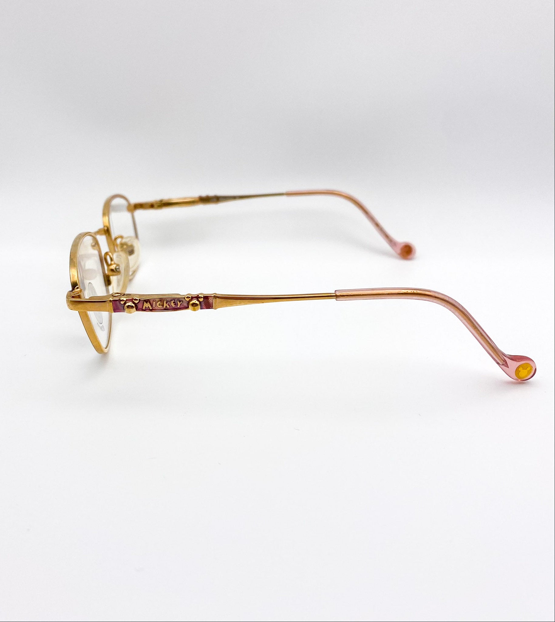 Gold eyeglasses on a white background